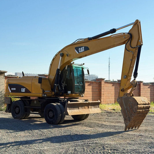 Used CAT M320D2 wheel excavator side view for road and municipal work
